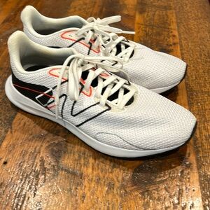 New Balance Men’s Sneaker. White with black and orange stitching. Size 9. EUC